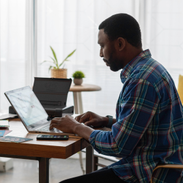 A man sitting and using a computer