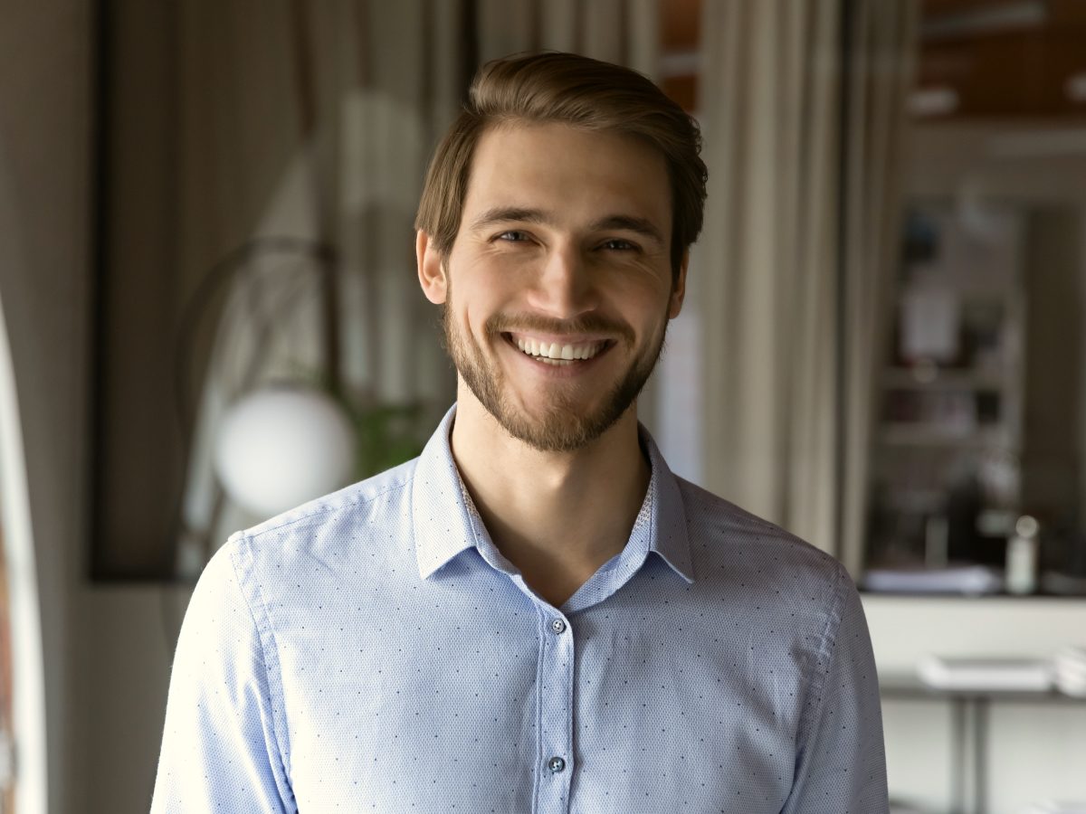 Portrait of a white man smiling and looking at the camera